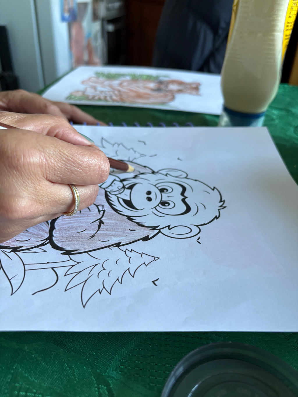 Person coloring a cartoon character on a piece of paper with a marker.