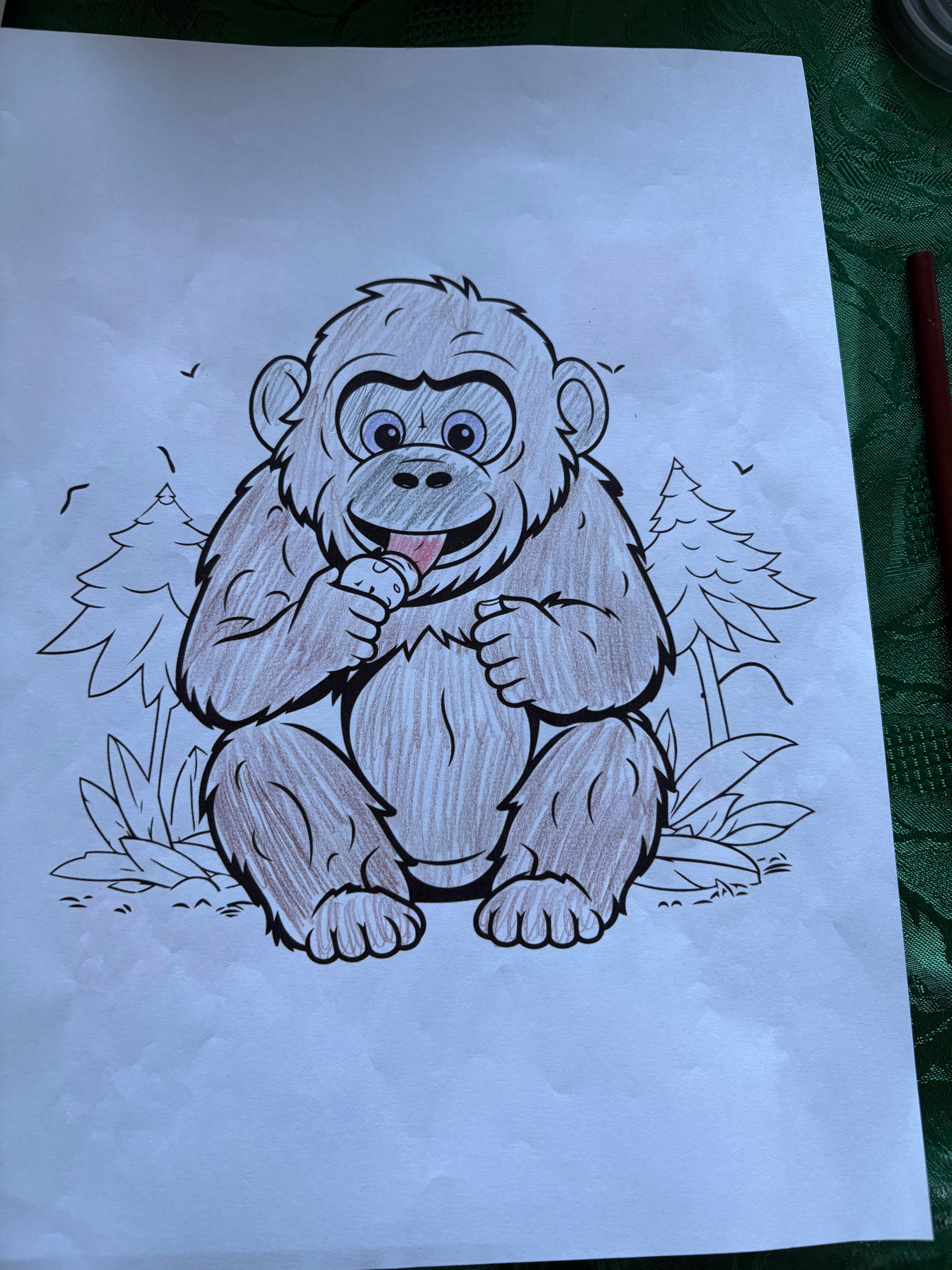 Doodle of a monkey on a white sheet of paper with a pen visible.
